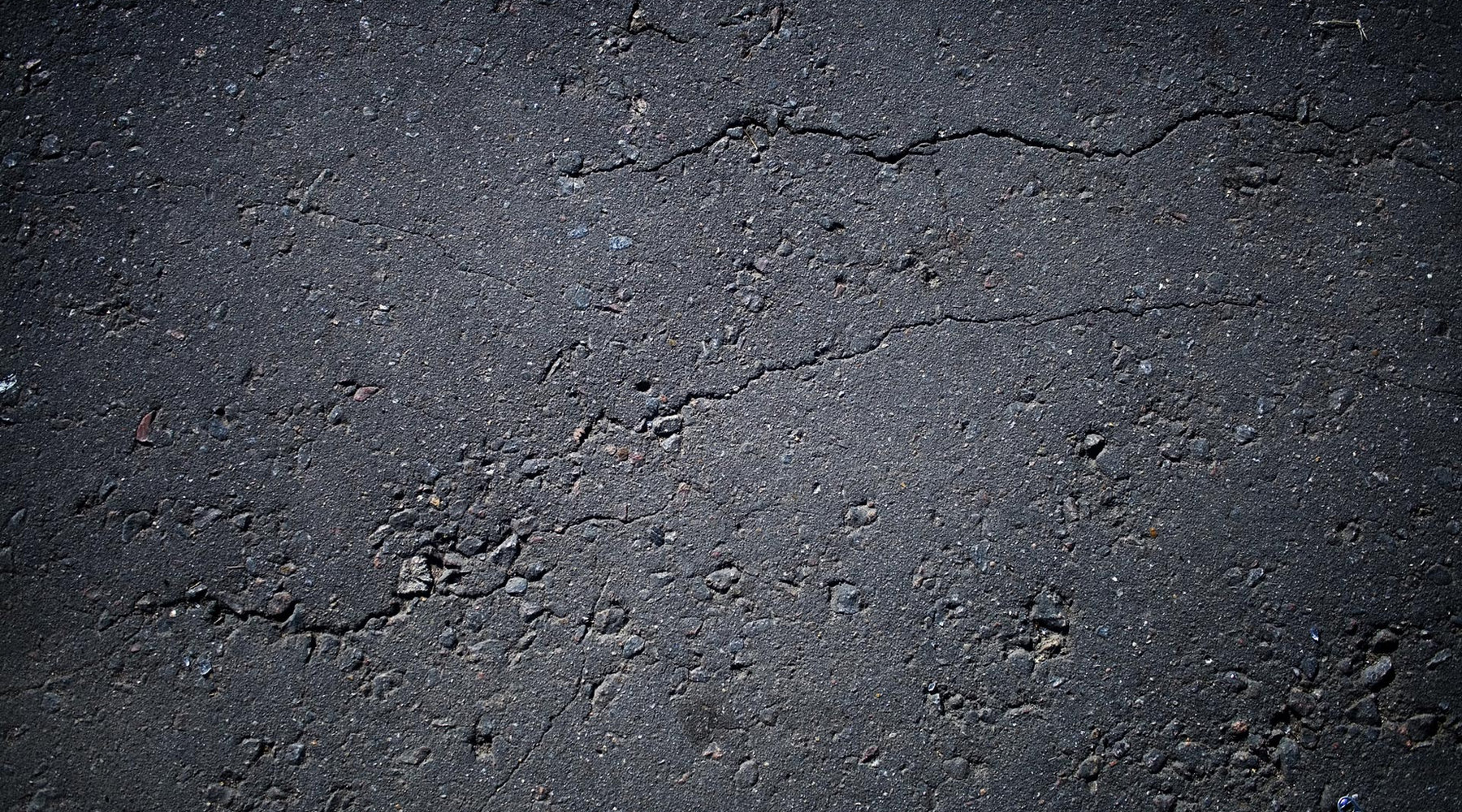 Close-up of worn tarmac road surface